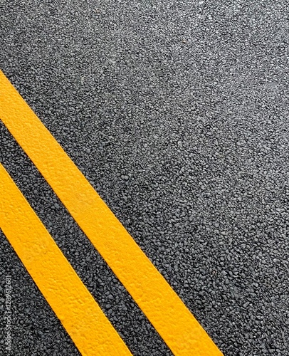 Double yellow lines freshly painted on a resurfaced asphalt road in the UK to restrict parking. 