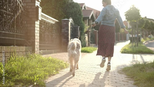 Girl Joyfully Walking And Hopping Outdoors With Adorable Dog