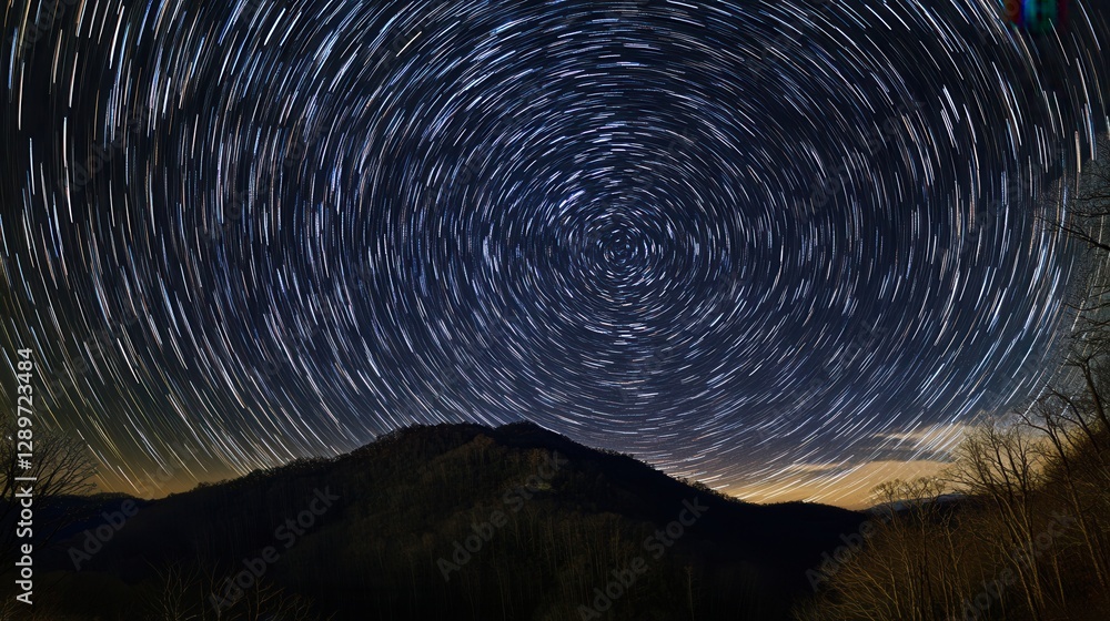 Fototapeta premium Star Trails Above Mountain Landscape Captured in Long Exposure Photography at Night Sky with Beautiful Celestial Patterns