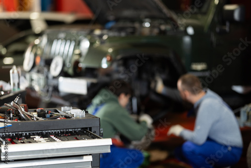 Workshop for car repair with table with different tools photo