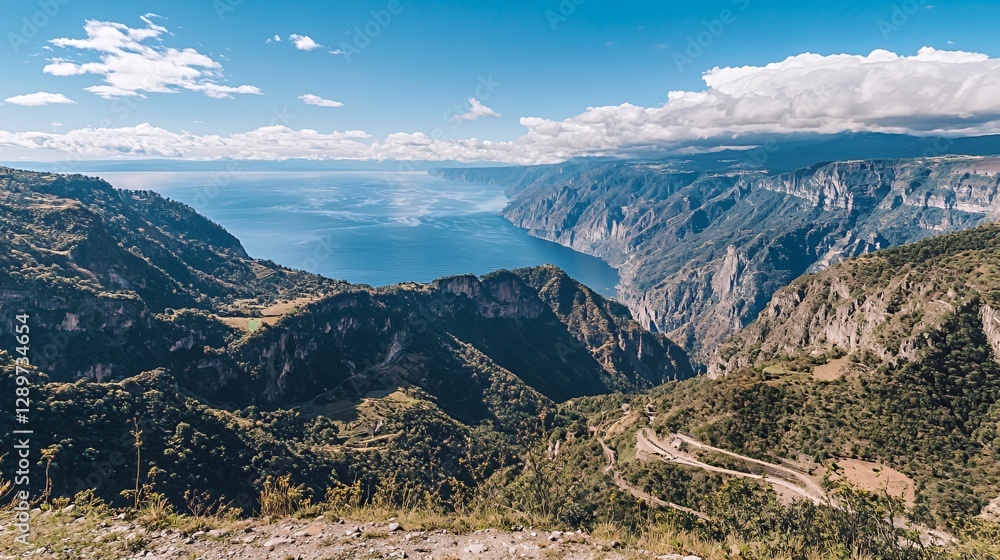 Panoramic View of a Mountainous Valley and Lake Under a Bright Sunny Sky Panoramic View of a Mountainous Valley and Lake Under a Bright Sunny Sky