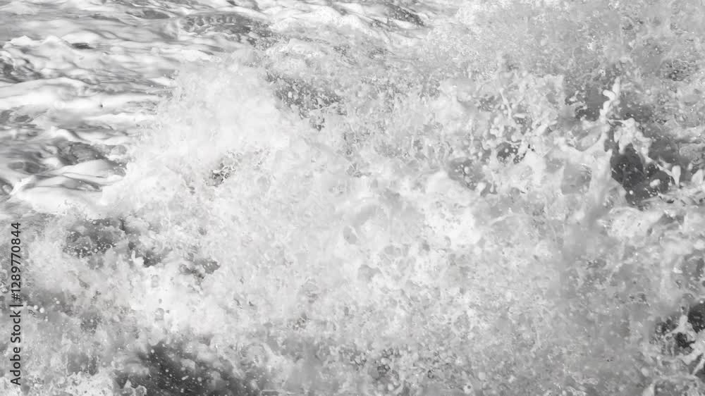 Video of dramatic ocean waves crash against dark coastal rocks, creating splashes and foamy water. A powerful nature scene ideal for themes of strength, resilience, and seascape backgrounds Video of dramatic ocean waves crash against dark coastal rocks, creating splashes and foamy water. A powerful nature scene ideal for themes of strength, resilience, and seascape backgrounds