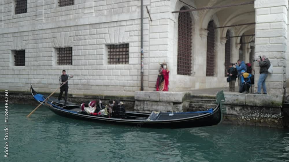 Venice, Italy - People dressed in carnival masks are photographed by tourists in the scenery of the ancient Venetian palaces Venice, Italy - People dressed in carnival masks are photographed by tourists in the scenery of the ancient Venetian palaces