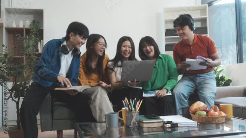 Five young Asian students engage in online study on campus, collaborating on research, projects. They help each other with assignments, gaining valuable experience and preparing for future careers.
