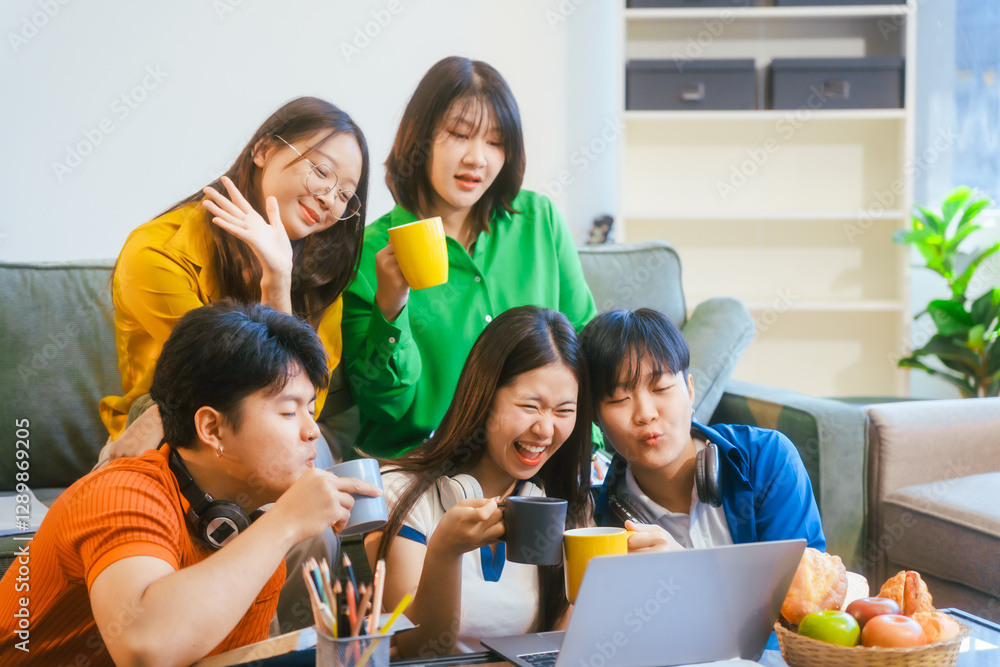 Fototapeta premium Five young Asian students engage in online study on campus, collaborating on research, projects. They help each other with assignments, gaining valuable experience and preparing for future careers.