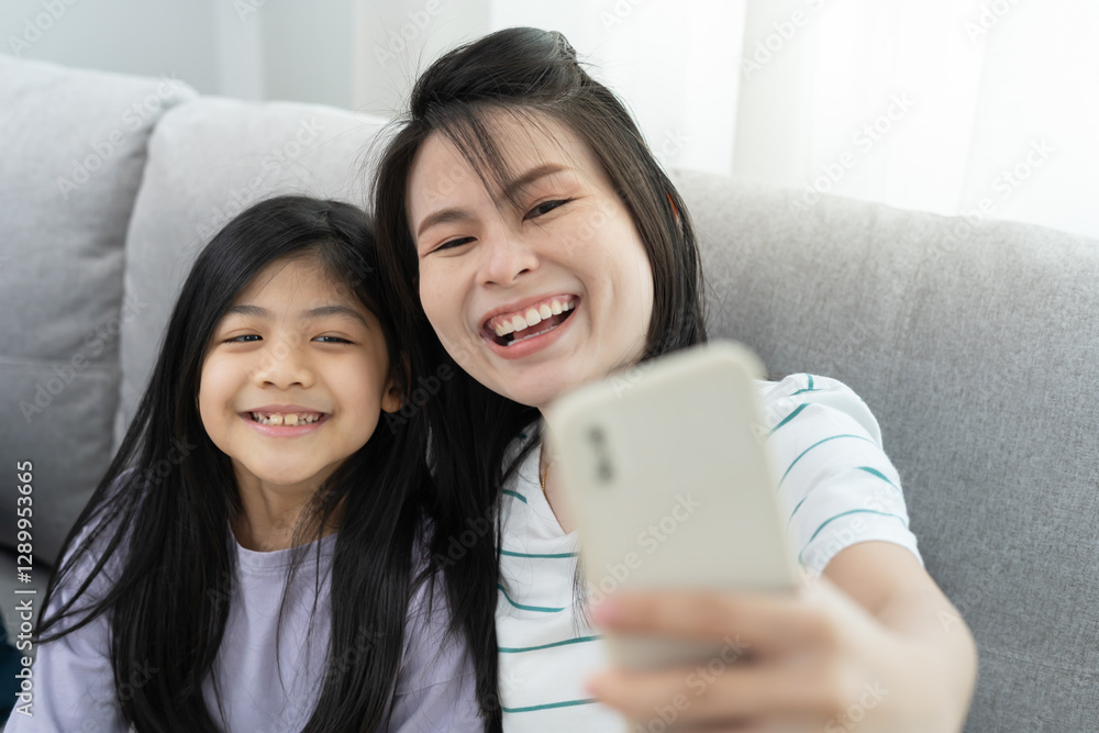 Moving house, relocation. Mother and daughter smile and take a photo after move to new home, inside the room was a cardboard box contain personal belongings and furniture. move in the new apartment Moving house, relocation. Mother and daughter smile and take a photo after move to new home, inside the room was a cardboard box contain personal belongings and furniture. move in the new apartment