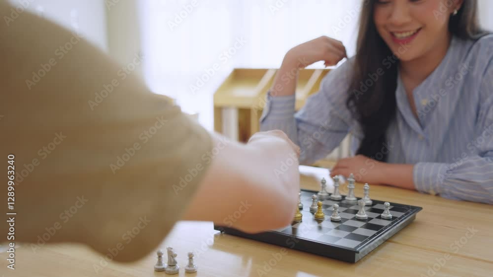 Asian man and woman playing chess game during competition in chess club. Asian man and woman playing chess game during competition in chess club.