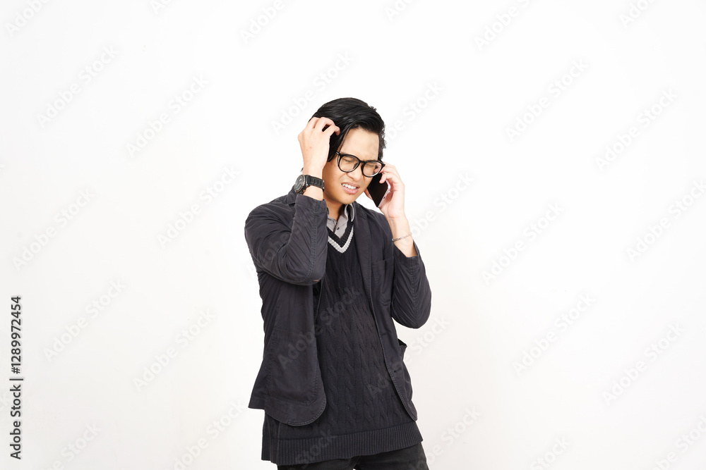 Headache while on phone Of Handsome Asian Man Isolated On White Background Headache while on phone Of Handsome Asian Man Isolated On White Background