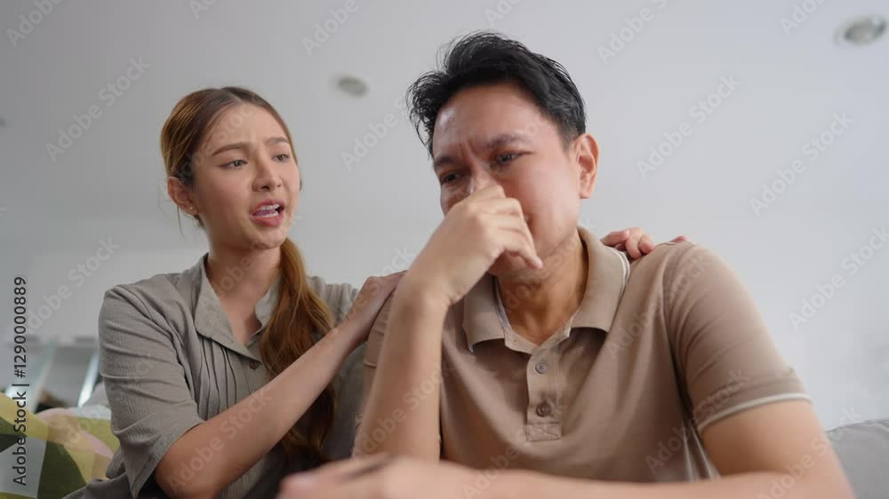 Asian wife comforting upset husband crying with tears for house problem. Asian wife comforting upset husband crying with tears for house problem.