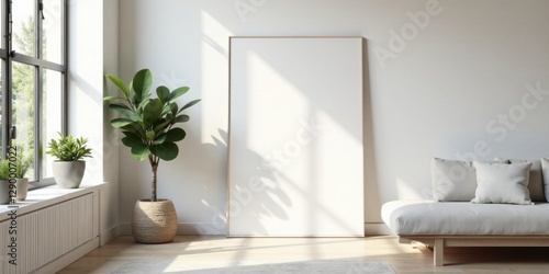 Sunlight illuminates a minimalist living room with a large blank canvas, potted plants, and a light-colored sofa
