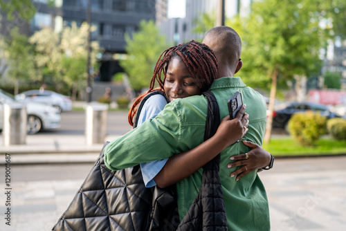 Photos Smiling black wife laugh and hug husband tightly, emotional family reunion outdoors