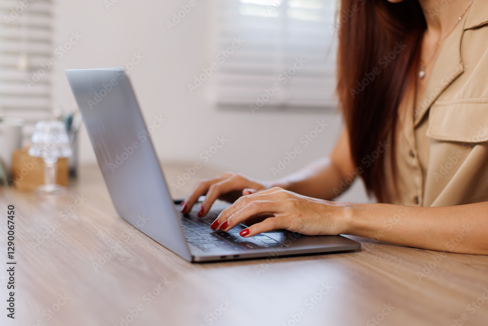 Fototapeta premium Brunette mid aged business asian woman sitting at the office using laptops for work.Technology business planning.