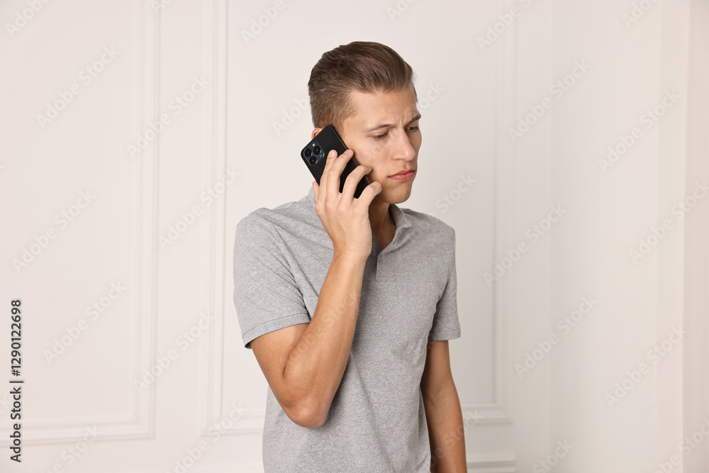 Frustrated man calling hotline for mental health help indoors Frustrated man calling hotline for mental health help indoors