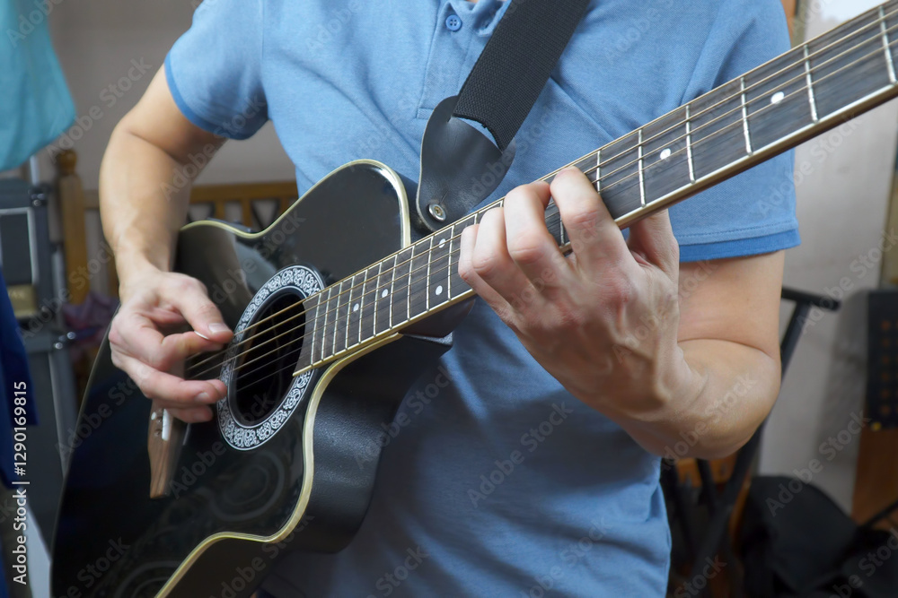 Fototapeta premium Man plays an acoustic guitar