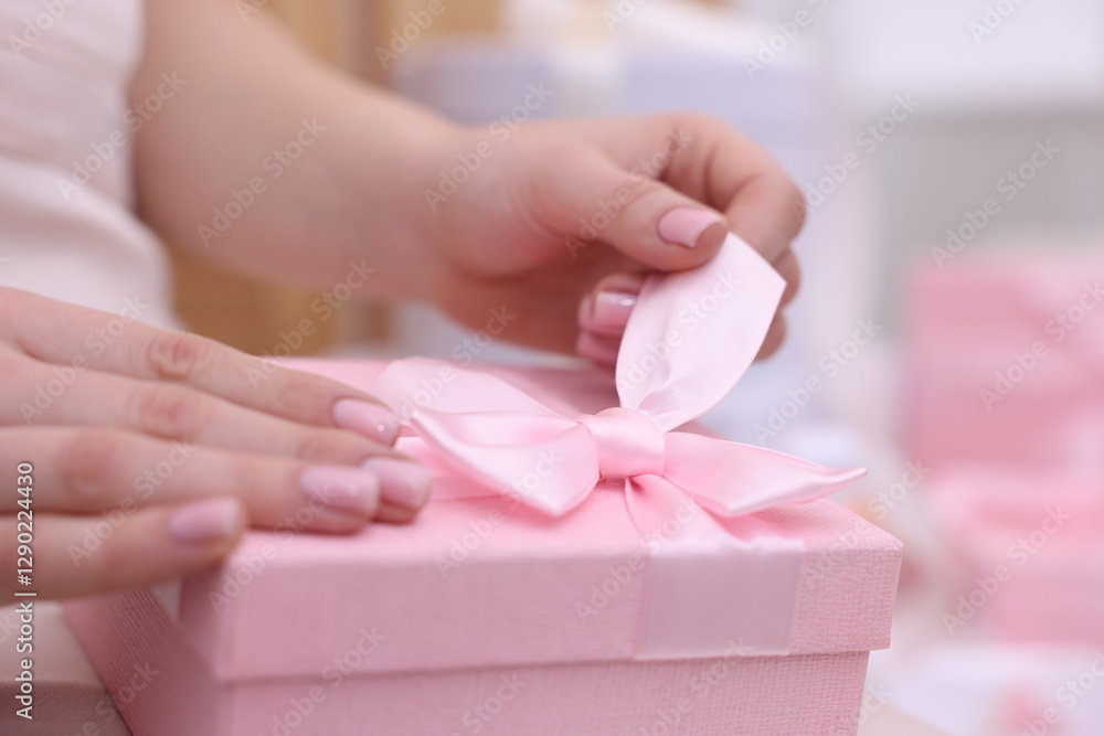 Bride opening beautiful wedding gift indoors, closeup Bride opening beautiful wedding gift indoors, closeup