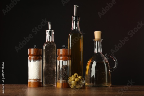 Wallpaper Mural Salad dressings, spices and olives on wooden table against black background Torontodigital.ca