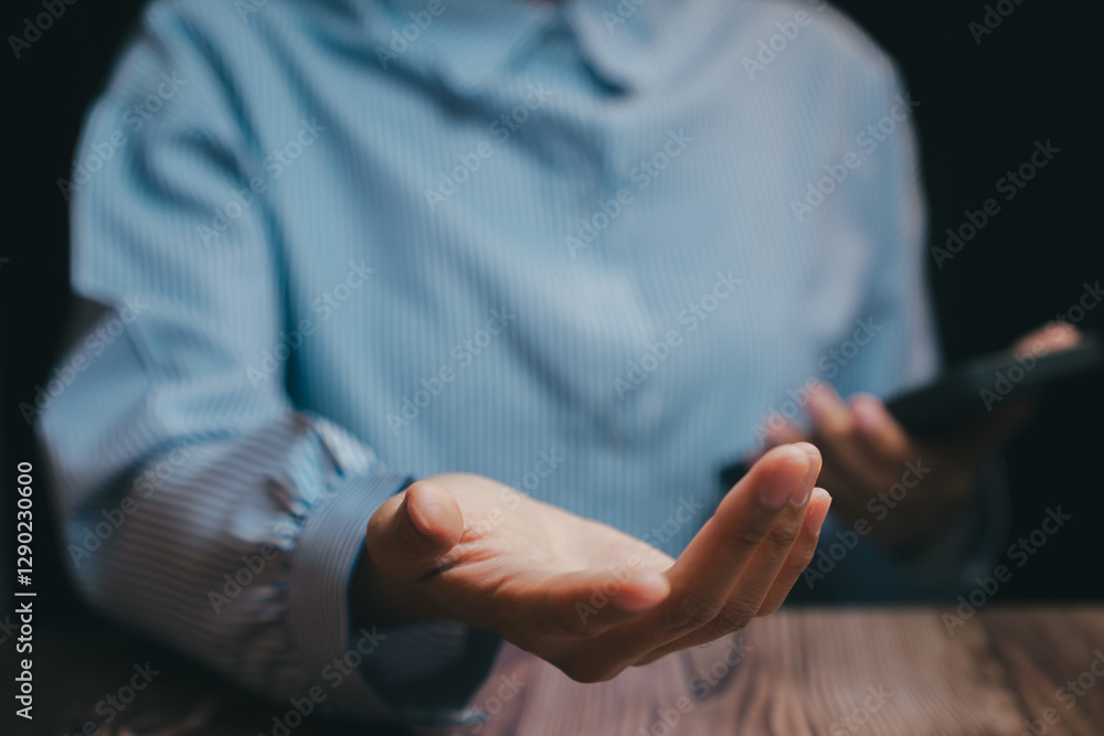Open Hand Gesture in Blue Shirt with Smartphone in Dark Setting, Business concept Open Hand Gesture in Blue Shirt with Smartphone in Dark Setting, Business concept