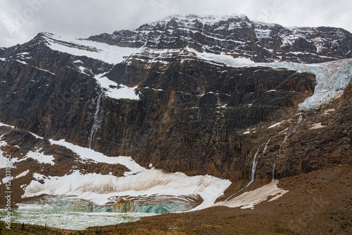 This image depicts a rugged mountainous landscape adorned with stunning glacial formations, emphasizing the power and beauty of nature's forces on display.