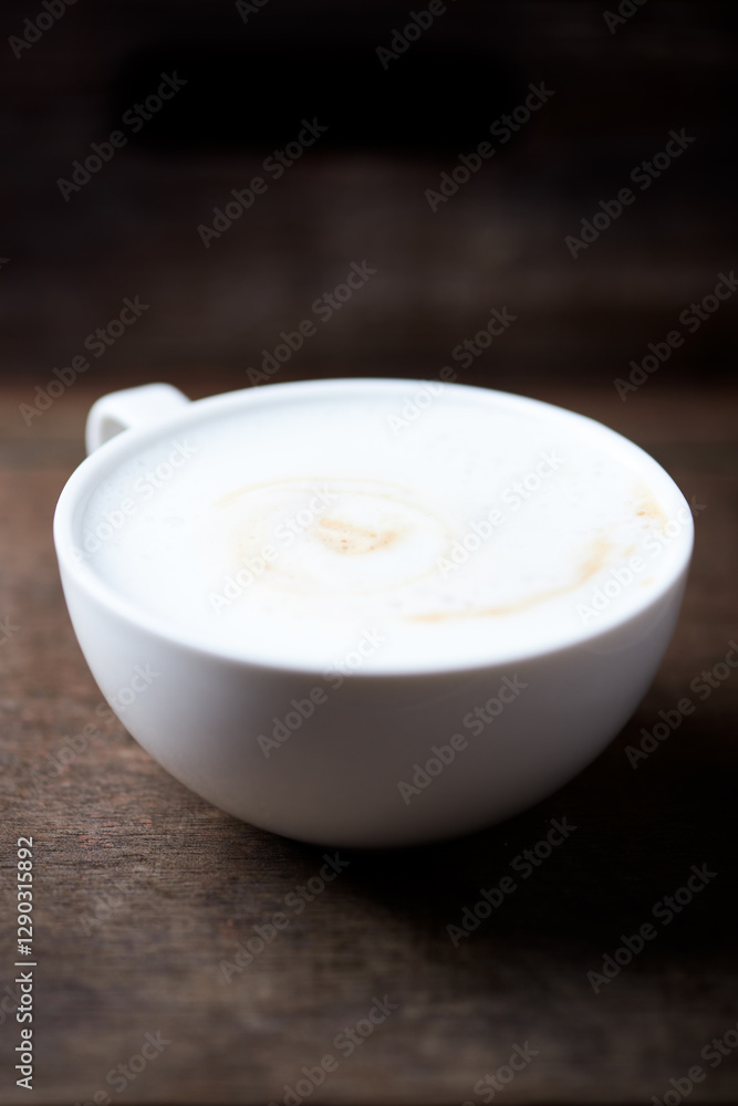 Cappuccino on dark wooden background. Soft focus. Close up. Cappuccino on dark wooden background. Soft focus. Close up.