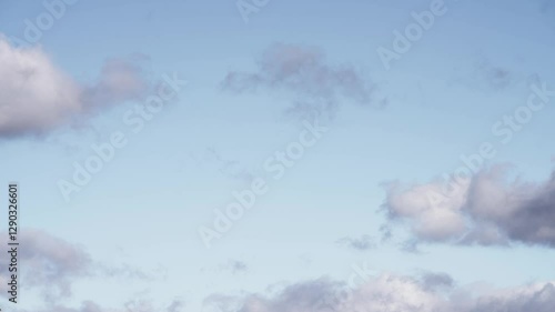 Floating Cumulus Clouds Under a Vibrant Blue Sky