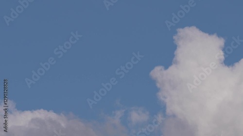Floating Cumulus Clouds Under a Vibrant Blue Sky