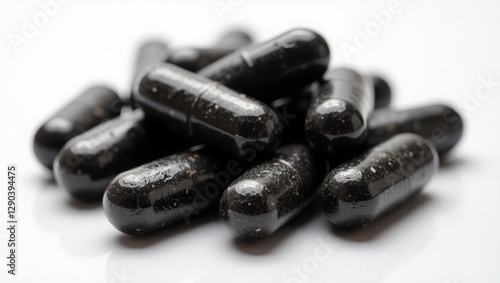 Shilajit capsule. Pills are black and have lot of black flakes