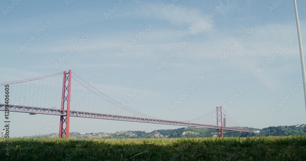 Fototapeta premium Red suspension bridge in Portugal, view of the Statue of Christ in Almada, Portugal