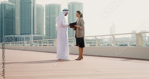 Canvas Print A business woman of European appearance shows her Arab partner documents while s