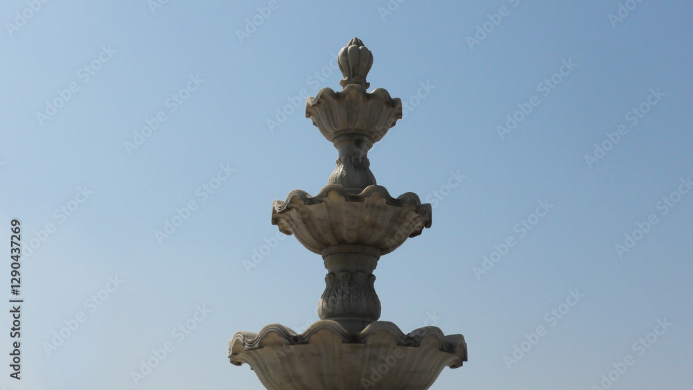 Elegant white marble sculpture with decorated curves Elegant white marble sculpture with decorated curves