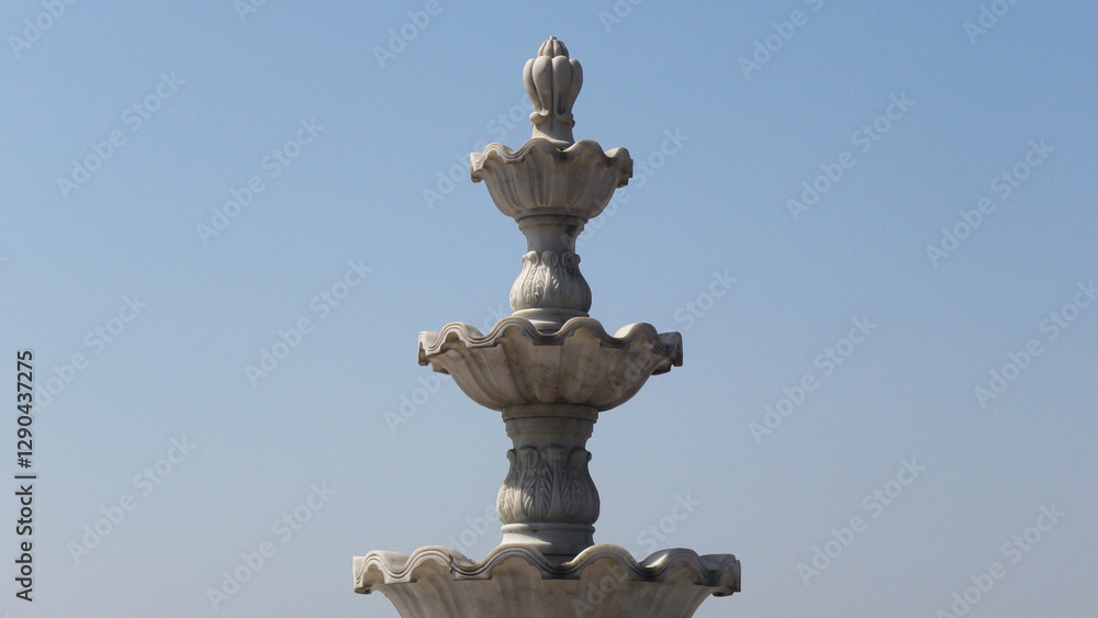 Elegant white marble sculpture with decorated curves Elegant white marble sculpture with decorated curves