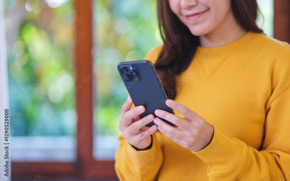 Closeup image of a woman holding and using smart phone at home Closeup image of a woman holding and using smart phone at home