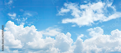 Serene blue sky with fluffy white clouds, vibrant backdrop, clouds positioned across the upper third, ideal for presentations or backgrounds. photo