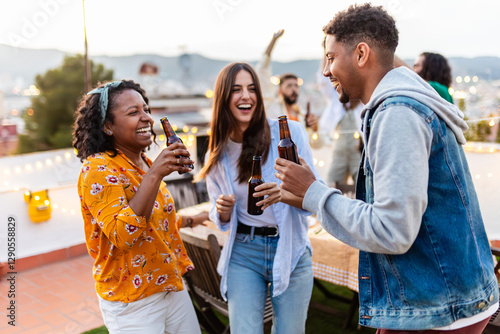 Photography Young group of diverse friends enjoying rooftop summer party together