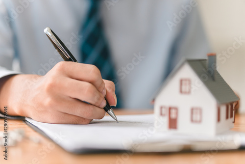 Close-up view of real estate contract signing in a business environment for property ownership