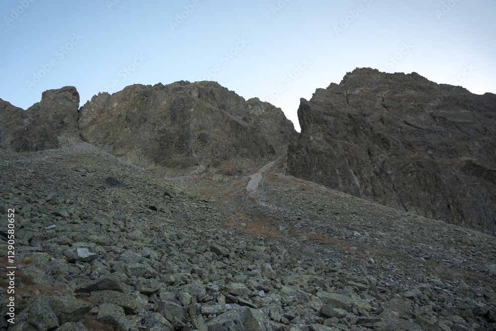 Travel along a marked mountain trail in the High Tatras. Landscape of high mountains.
Travel along a marked mountain trail in the High Tatras. Landscape of high mountains.