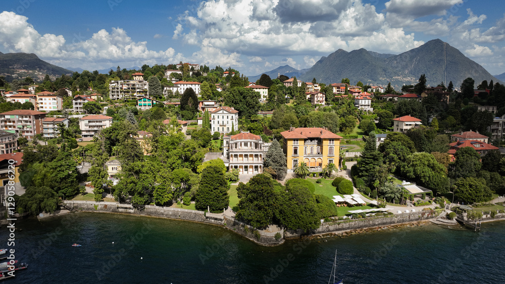 Stunning view of Lake Maggiore with lush greenery and vibrant villas during a sunny day Stunning view of Lake Maggiore with lush greenery and vibrant villas during a sunny day