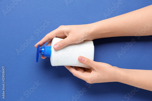 Female hands with bottle of...
