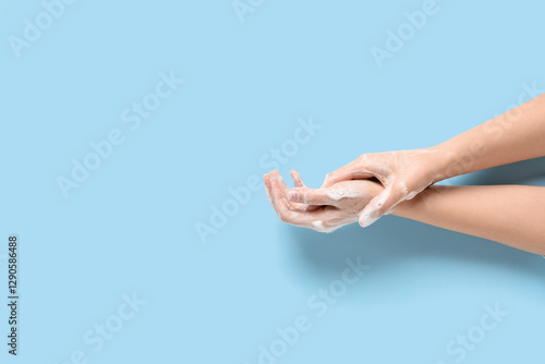 Woman washing hands with so...