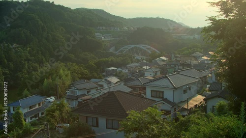 Wallpaper Mural Sunset Over Japan’s Countryside - A breathtaking countryside view of a Japanese village among mountains, framed by golden sunlight and lush trees Torontodigital.ca