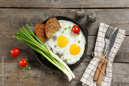 Frying pan with tasty eggs,...