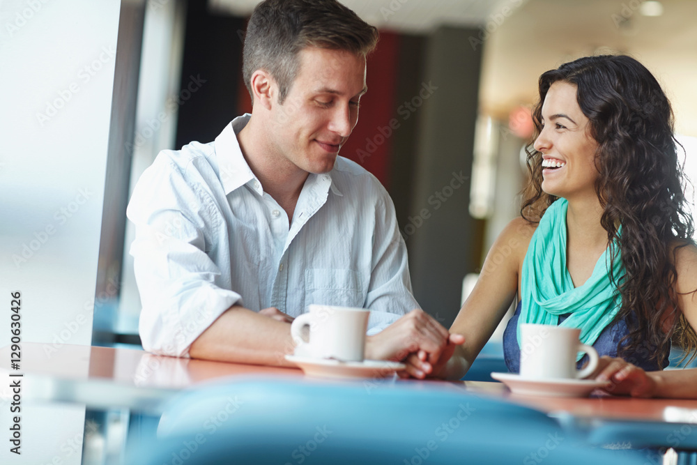 Obraz premium Couple, holding hands and happy at cafe for talk, bonding or love with funny joke in morning. Man, woman and support with conversation, drinks or tea with smile, memory or chat on date at coffee shop