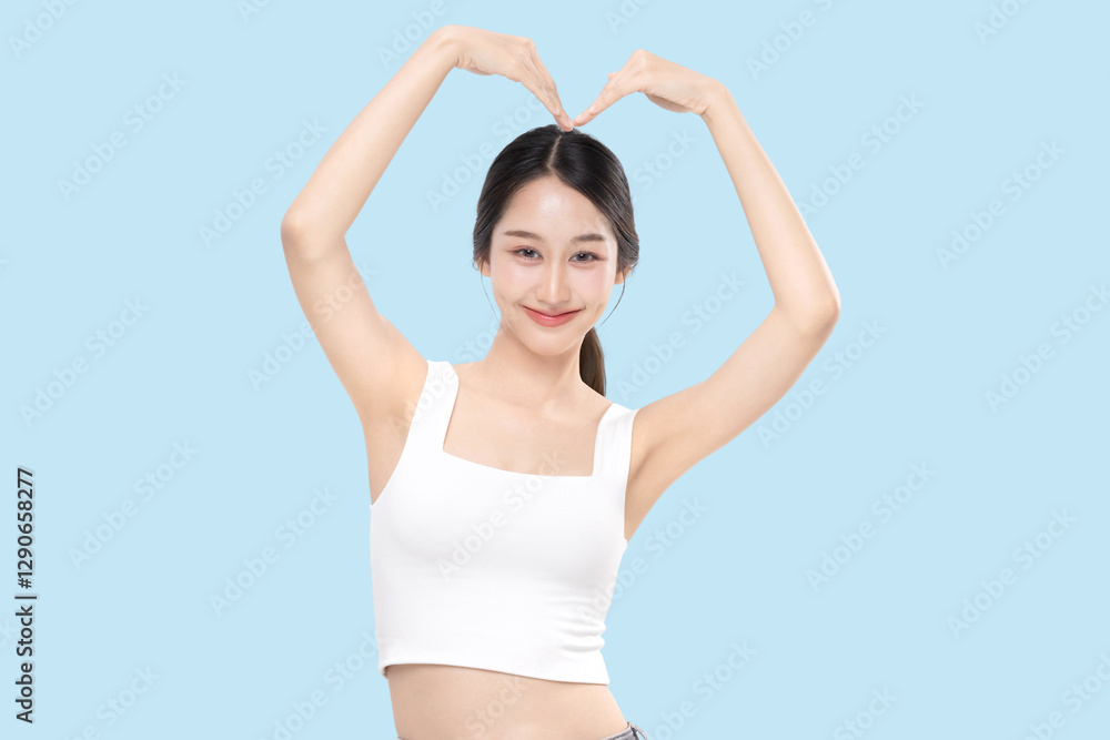 Happy young Asian beautiful woman with K-beauty make up style and healthy and perfect skin isolated on blue background for skincare commercial product advertising. Happy young Asian beautiful woman with K-beauty make up style and healthy and perfect skin isolated on blue background for skincare commercial product advertising.