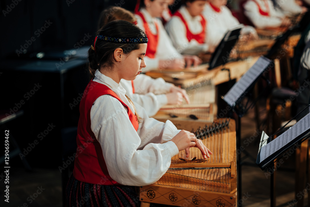 Obraz premium Young Latvian Musicians Performing Traditional Kokles Ensemble