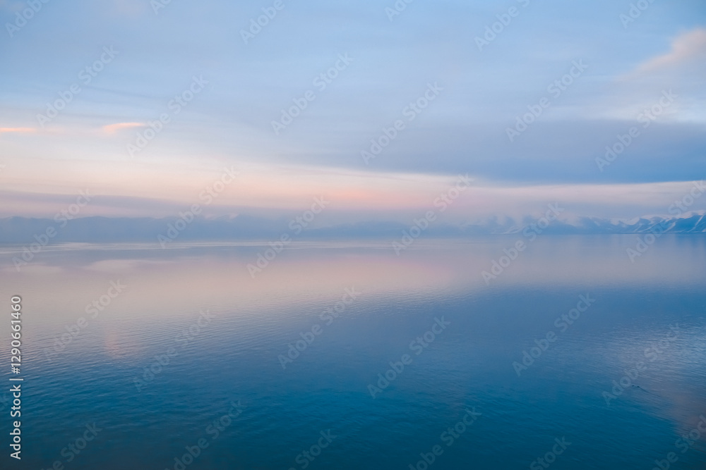 Beautiful sunset over the lake. Sunrise on the sea. Beautiful landscape with lake, mountains and sunset. Reflection in the water Beautiful sunset over the lake. Sunrise on the sea. Beautiful landscape with lake, mountains and sunset. Reflection in the water