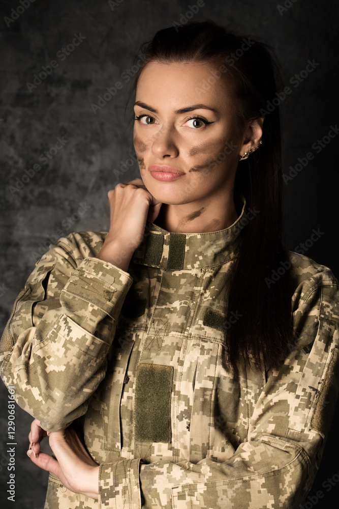 Beautiful military woman in Ukrainian military uniform with camouflage makeup on her face