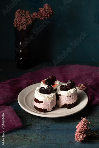 Obraz na płótnie Delicious cream cakes with blackberries on a plate. Still life in a rustic style w salonie