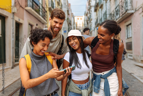Group of tourists laughing together while using smart phone in lisbon