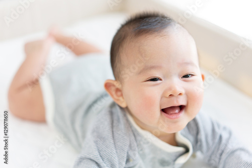 Happy baby playing on bed