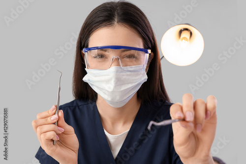 Young female dentist in med...