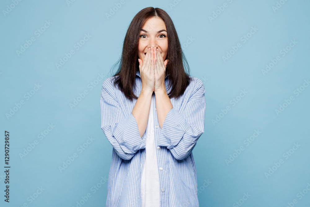 Young shocked surprised happy Caucasian woman she wears shirt casual clothes cover mouth with hand look camera isolated on plain pastel light blue cyan background studio portrait. Lifestyle concept. Young shocked surprised happy Caucasian woman she wears shirt casual clothes cover mouth with hand look camera isolated on plain pastel light blue cyan background studio portrait. Lifestyle concept.